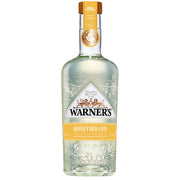 Flaske med Warners Honeybee Gin fremstillet med naturlig honning fra egne bikuber.