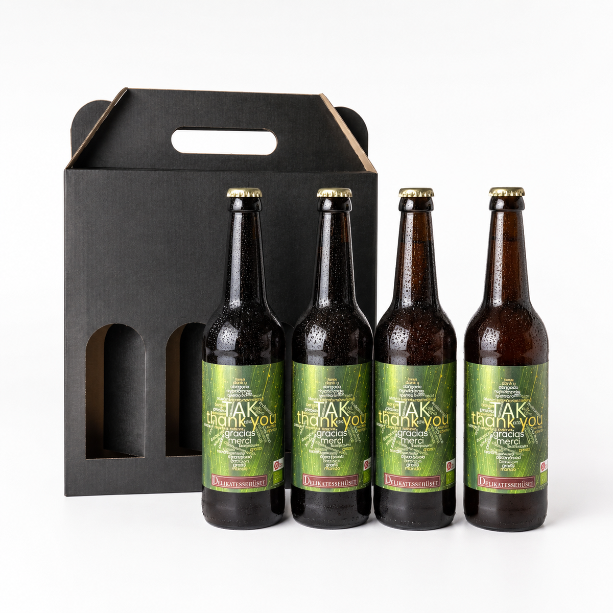 Gaveæske med 4 flasker ‘TAK’ øl fra Grauballe Bryghus, designet af Delikatessehuset som en gave til at sige tak.